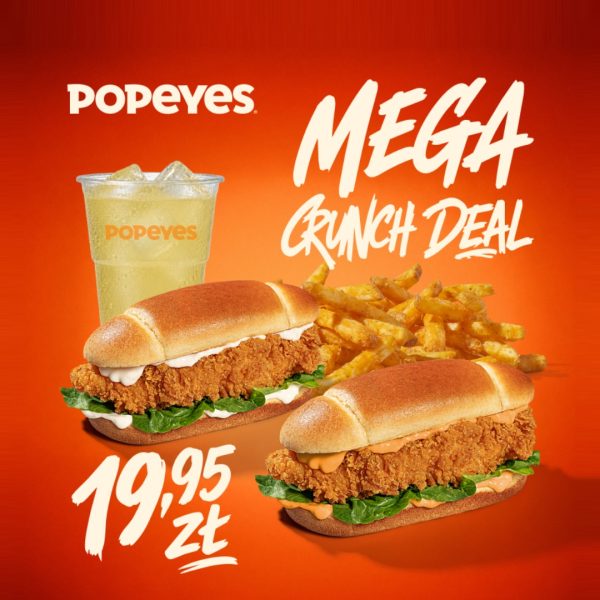 Zestaw Mega Crunch Deal z Popeyes na pomarańczowym tle, zawierający dwa sandwicze z kurczakiem, frytki i lemoniadę, z ceną 19,95 zł.